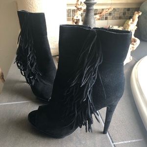 Black suede high heel fringed booties.